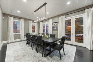 Dining space with french doors, recessed lighting, baseboards, and a chandelier