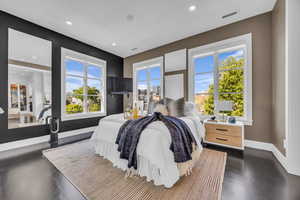 Bedroom with recessed lighting, multiple windows, and baseboards