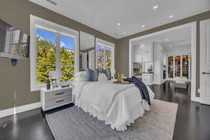 Bedroom with recessed lighting, dark wood-type flooring, and baseboards