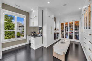 Kitchen featuring recessed lighting, white cabinets, dark wood finished floors, dark countertops, and baseboards