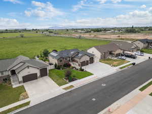 View of home, neighboring homes and field