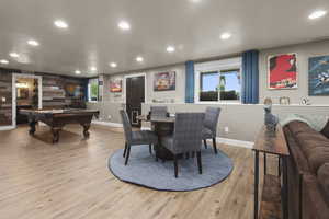 Entertaining room with recessed lighting, wood finished floors, and baseboards