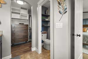 Private toilet in primary bathroom with walk in closet