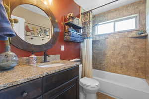 Full bathroom featuring vanity, toilet, and shower / bathtub combination w