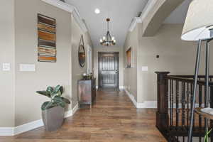Hallway with a chandelier, LVP finished floors