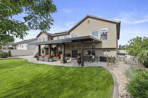 Rear view of property featuring a covered patio
