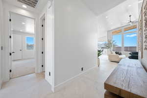 Corridor with recessed lighting and baseboards