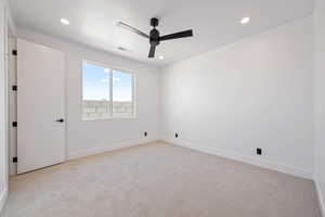 Spare room featuring ceiling fan, light carpet, recessed lighting, and baseboards