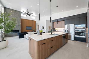 Kitchen featuring a sink, modern cabinets, appliances with stainless steel finishes, a high ceiling, and recessed lighting
