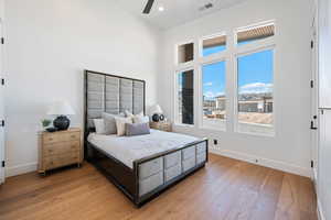 Bedroom featuring baseboards, light wood-type flooring, recessed lighting, and a ceiling fan