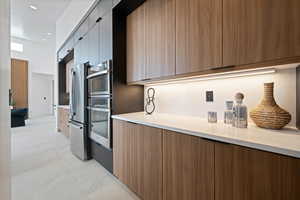 Kitchen with modern cabinets, stainless steel appliances, and light countertops