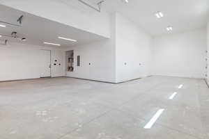 Garage with electric panel and baseboards