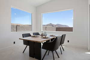 Dining room with baseboards and a mountain view