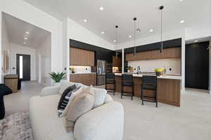 Living room with lofted ceiling and recessed lighting