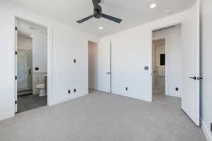Unfurnished bedroom featuring carpet, recessed lighting, ensuite bath, tile patterned floors, and baseboards