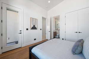 Bedroom featuring wood finished floors, baseboards, ensuite bath, recessed lighting, and a closet