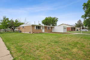 Ranch-style house with brick siding, a garage, and central AC unit