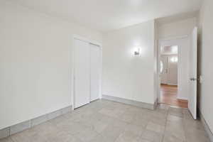 Spare room with light tile patterned floors and baseboards