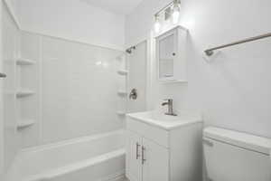 Full bathroom with shower / tub combination, vanity, and toilet