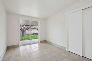 Empty room with light tile patterned floors