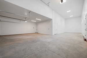 Garage with a garage door opener and baseboards