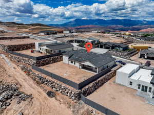 Aerial view of property and surrounding area featuring mountains