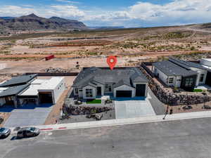 Aerial view of sparsely populated area featuring a desert landscape and a mountain backdrop