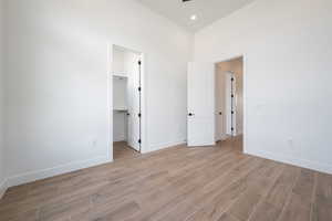 Spare room with light wood-style flooring, baseboards, and recessed lighting