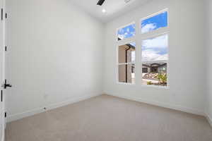 Spare room featuring light carpet, a ceiling fan, baseboards, recessed lighting, and high vaulted ceiling