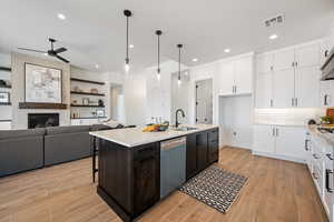 Kitchen featuring white cabinetry, light countertops, a ceiling fan, dishwasher, and recessed lighting