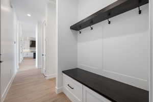 Mudroom featuring light wood-type flooring, baseboards, and recessed lighting