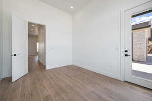 Unfurnished room featuring light wood-style floors, baseboards, and recessed lighting