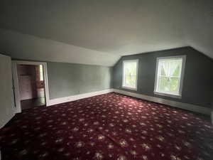 Large upstairs bedroom with carpet floors, and baseboards