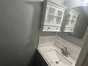 Bathroom with backsplash and vanity