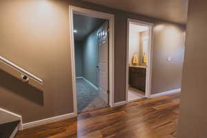 Corridor featuring wood finished floors and baseboards