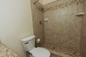 Bathroom with tiled shower and toilet