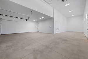 Garage with a garage door opener and baseboards