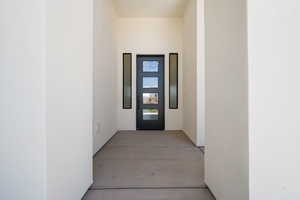 Doorway to property with stucco siding