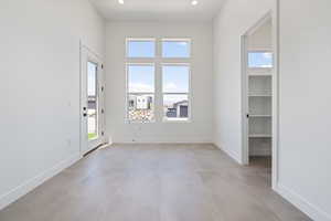 Spare room with concrete flooring, baseboards, and recessed lighting