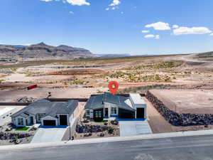 View of rural area featuring a mountain backdrop and a desert landscape
