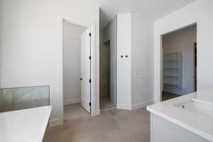 Bathroom with baseboards, a soaking tub, a tile shower, vanity, and tile patterned floors