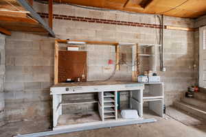 Unfinished basement featuring a workshop area