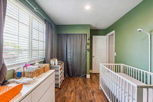 Bedroom featuring dark wood-style floors and recessed lighting