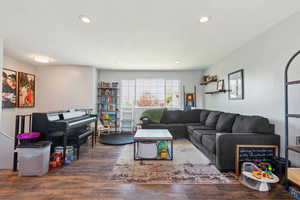 Living area with wood finished floors and recessed lighting