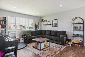 Living area featuring wood finished floors and recessed lighting