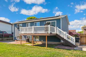 Rear view of house featuring a wooden deck, central AC unit, a patio area, and stairway
