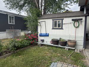View of outbuilding featuring fence