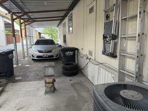 View of parking featuring a carport