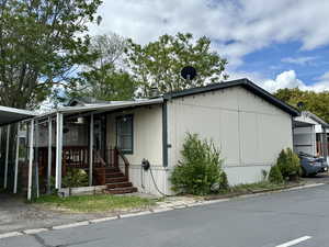 View of side of property featuring covered porch