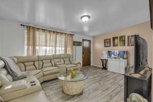 Living area with light wood finished floors and baseboards